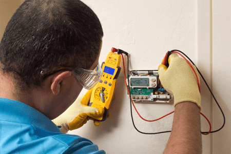 recalibrating thermostat by technician